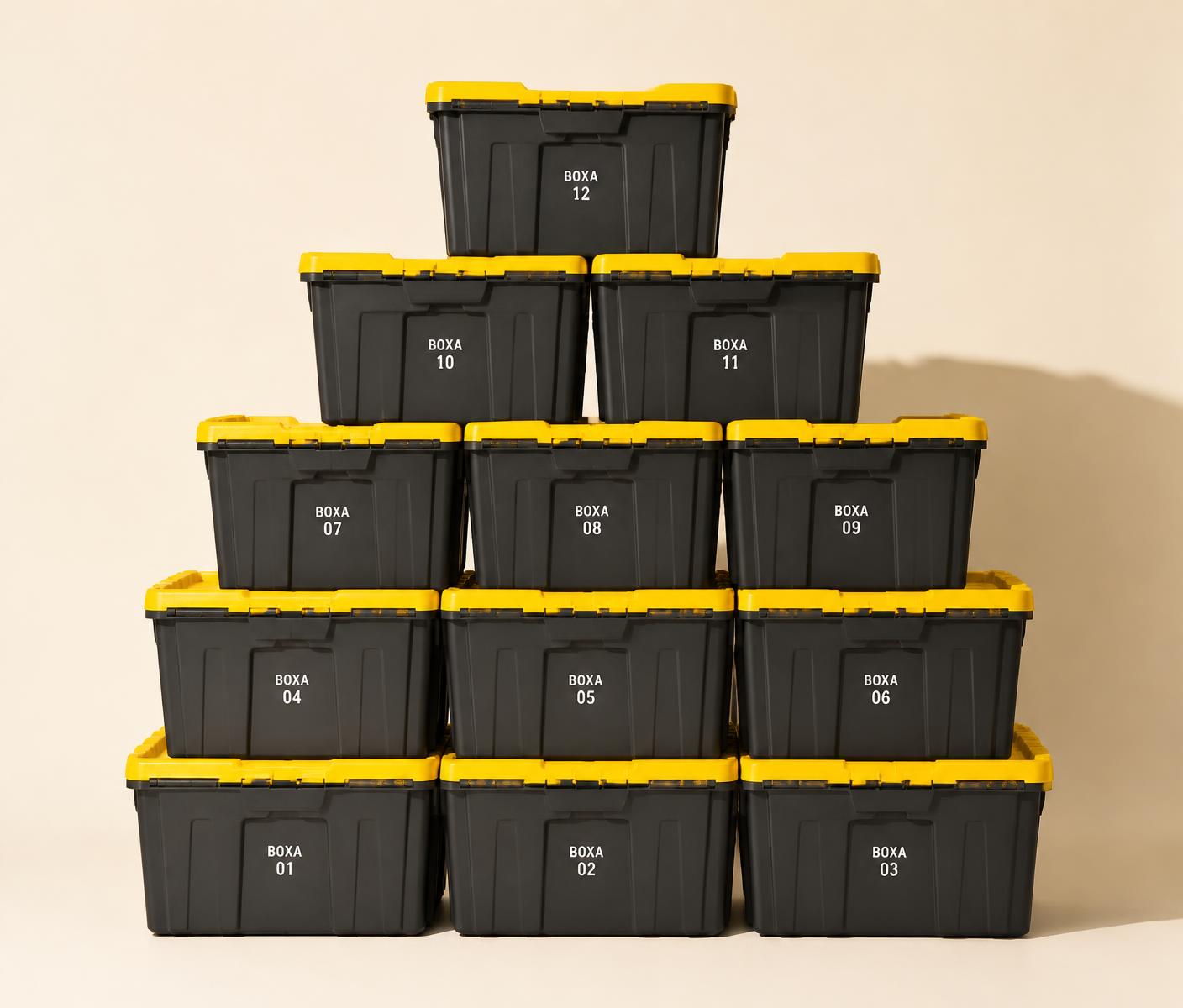 Stacked black BOXA moving crates with yellow lids